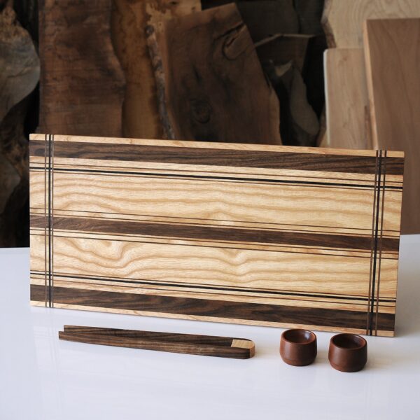 a wooden board with two small objects on a white surface