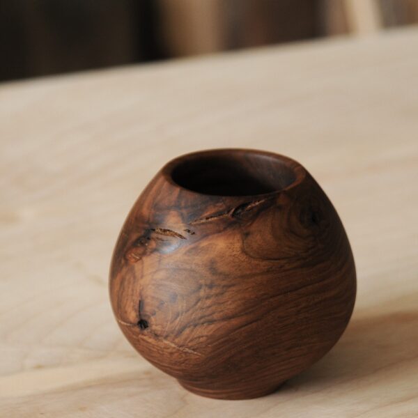 a round wooden bowl on a table